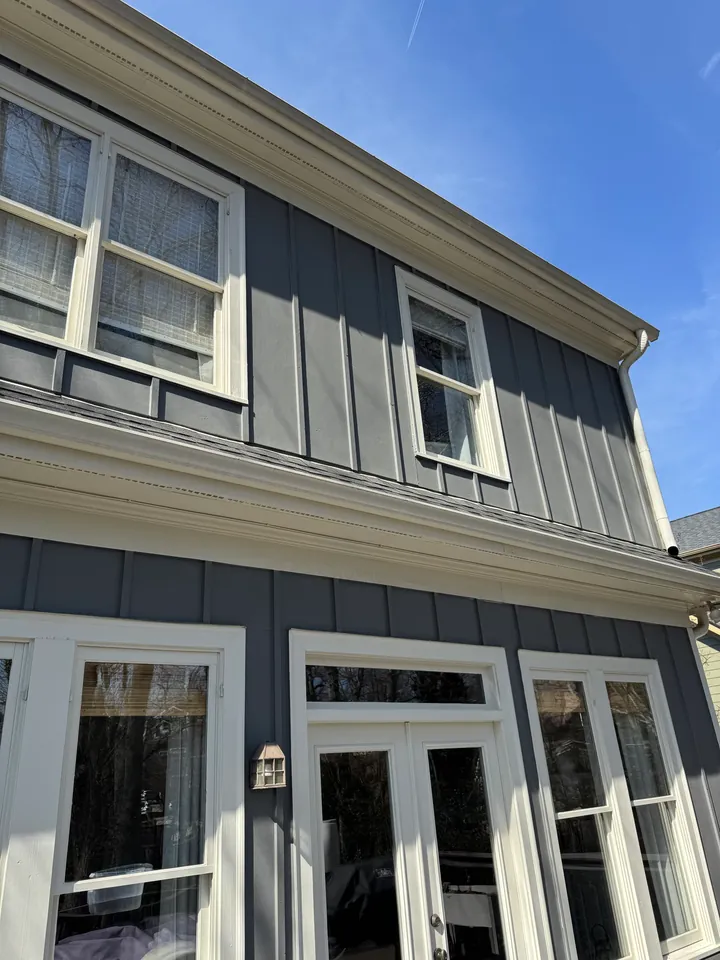 Gray house exterior with white windows, trim and doors.